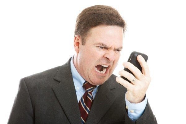 Angry Businessman Yelling into Phone