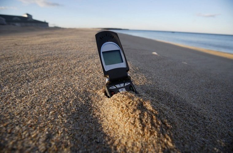 Cell phone in sand on Beach